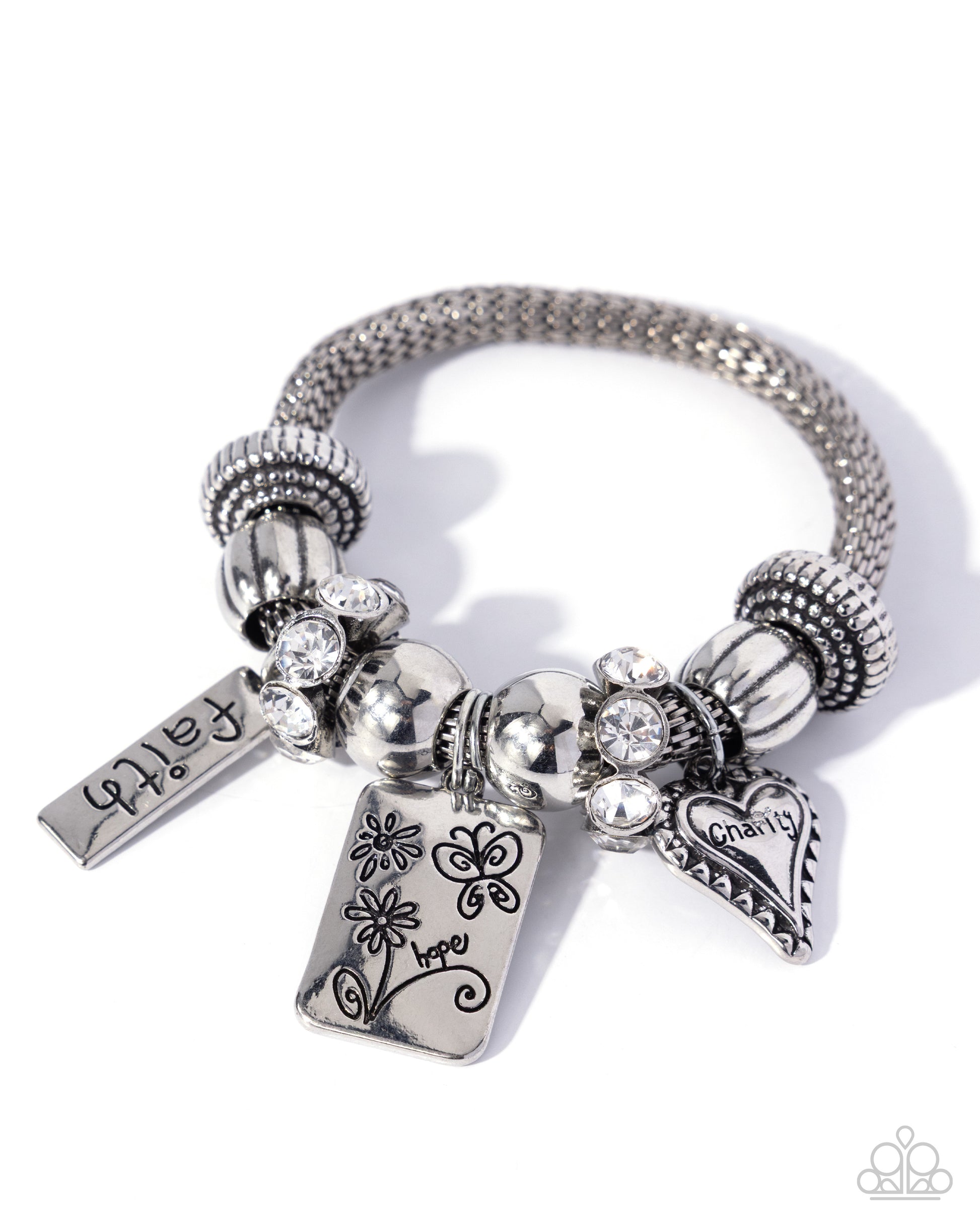 Silver bracelet with various charms on a white background
