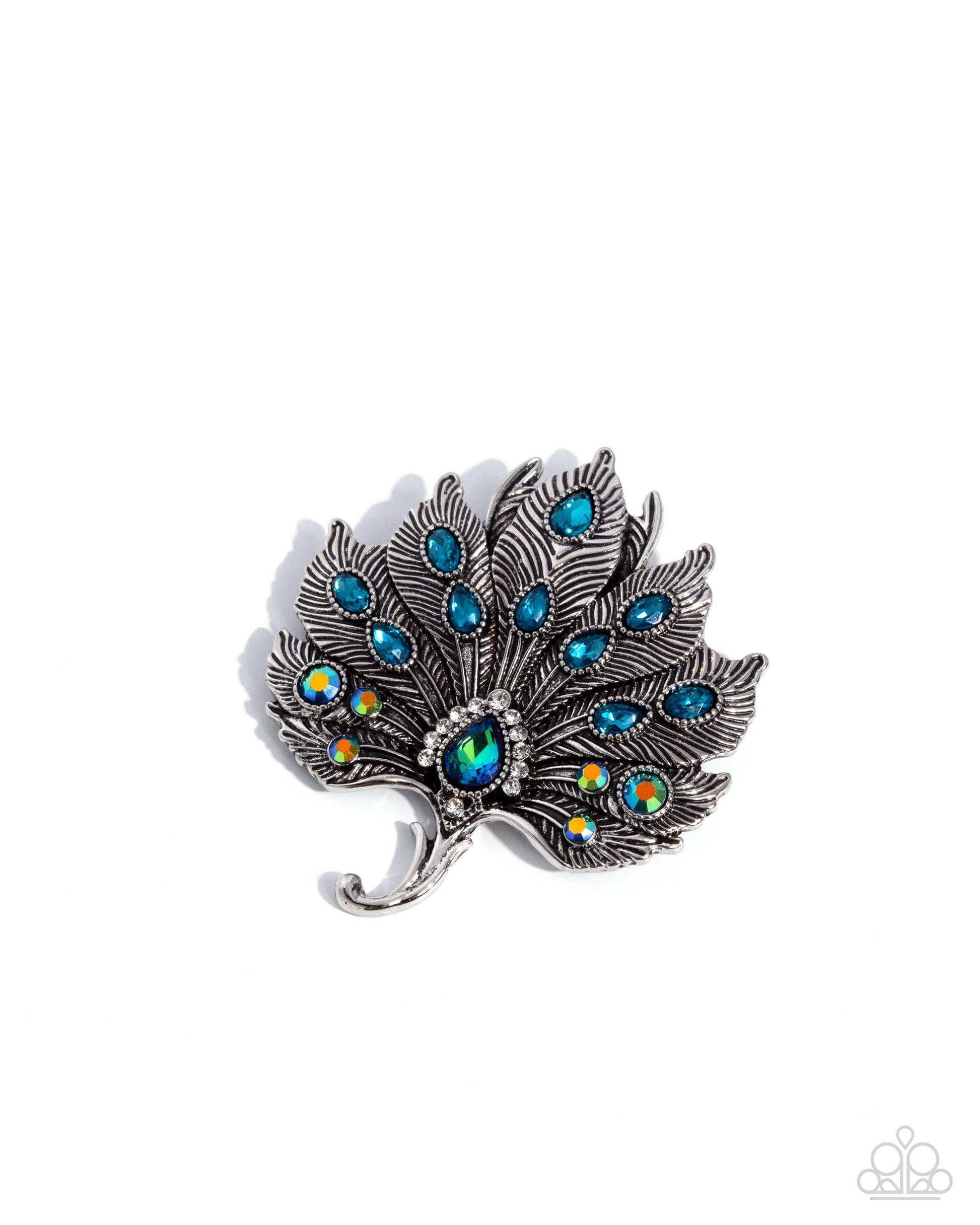 Peacock feather brooch with blue gemstones on a white background