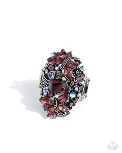 Decorative ring with purple and silver gemstones on a white background