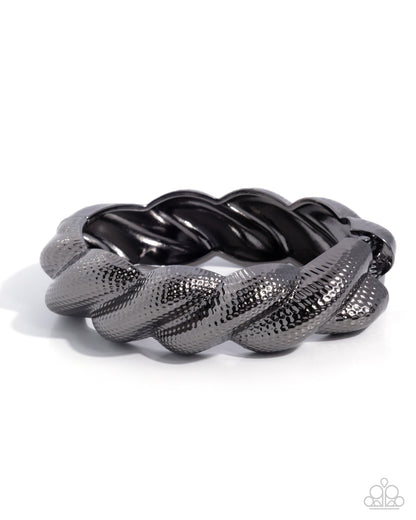 Black braided bracelet on a white background