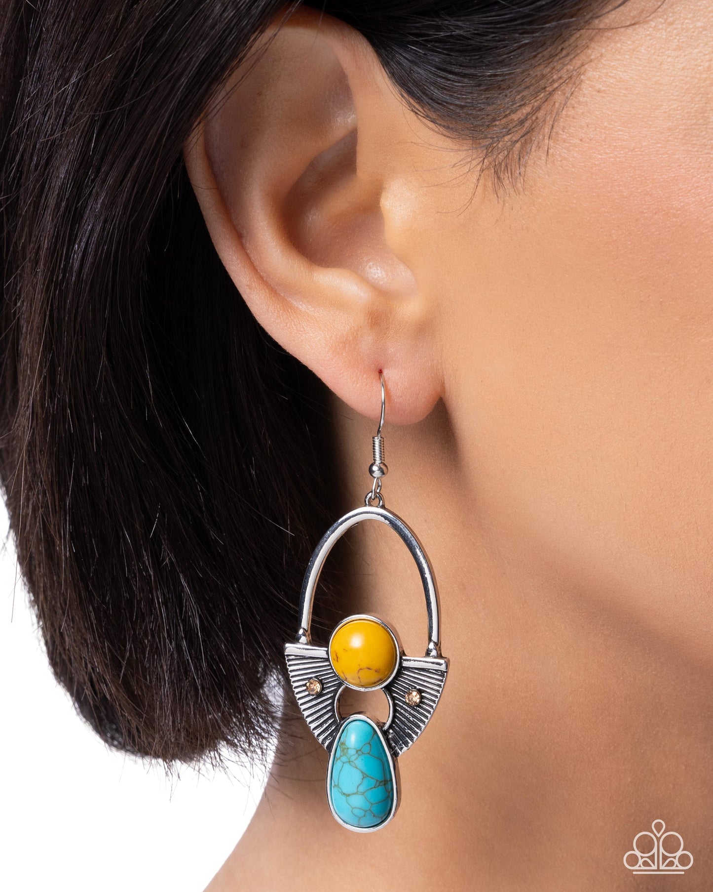 Earring with yellow and turquoise stones worn by a person