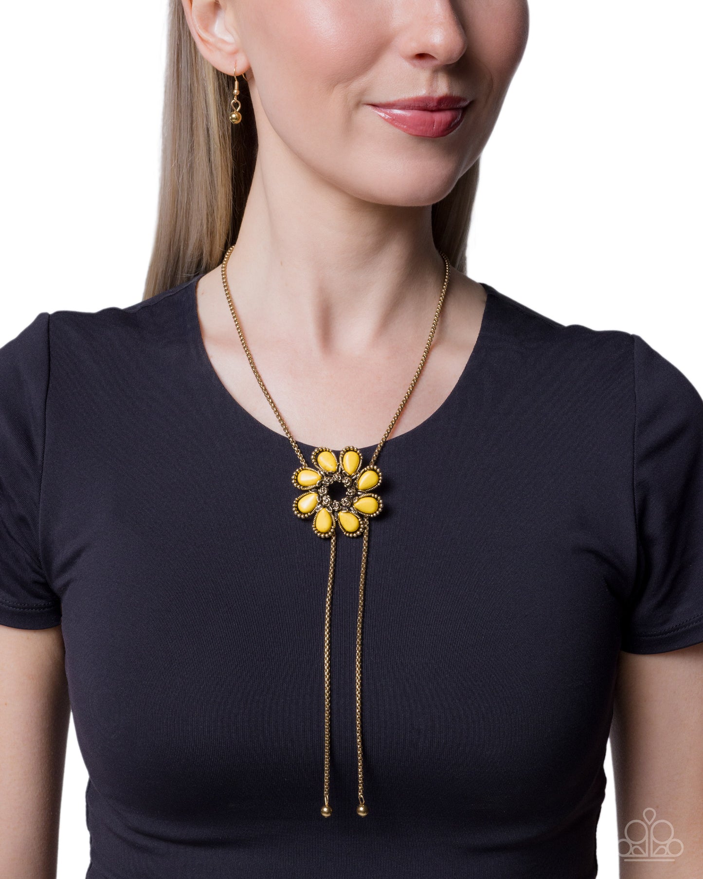 Woman wearing a black shirt with a yellow and gold necklace