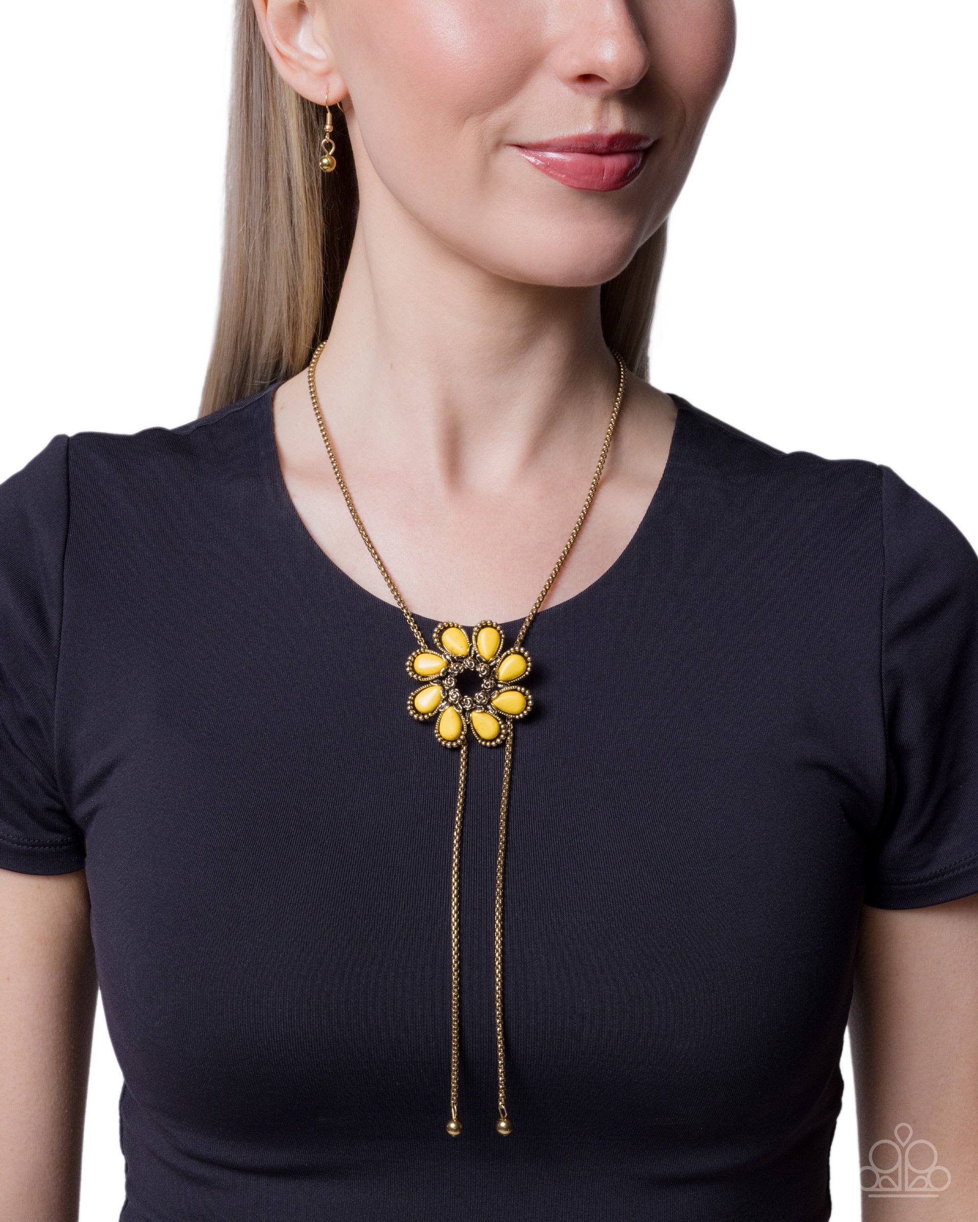Woman wearing a black shirt with a yellow and gold necklace