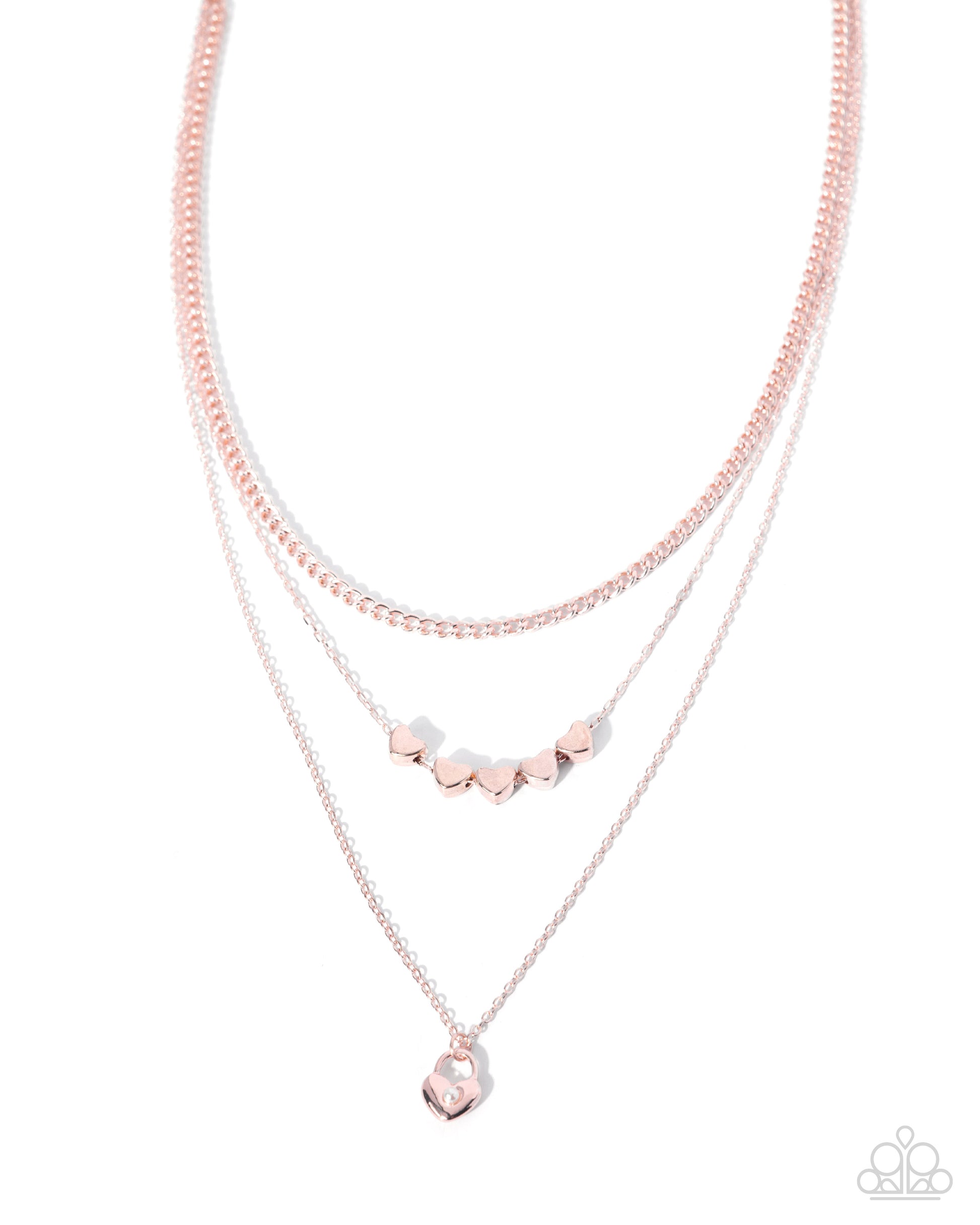 Layered pink and rose gold necklaces on a white background