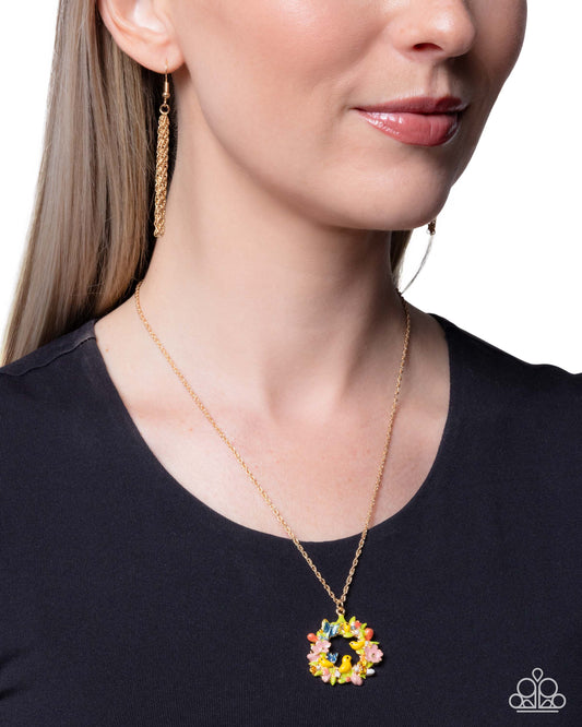 Woman wearing a colorful pendant necklace and earrings on a white background