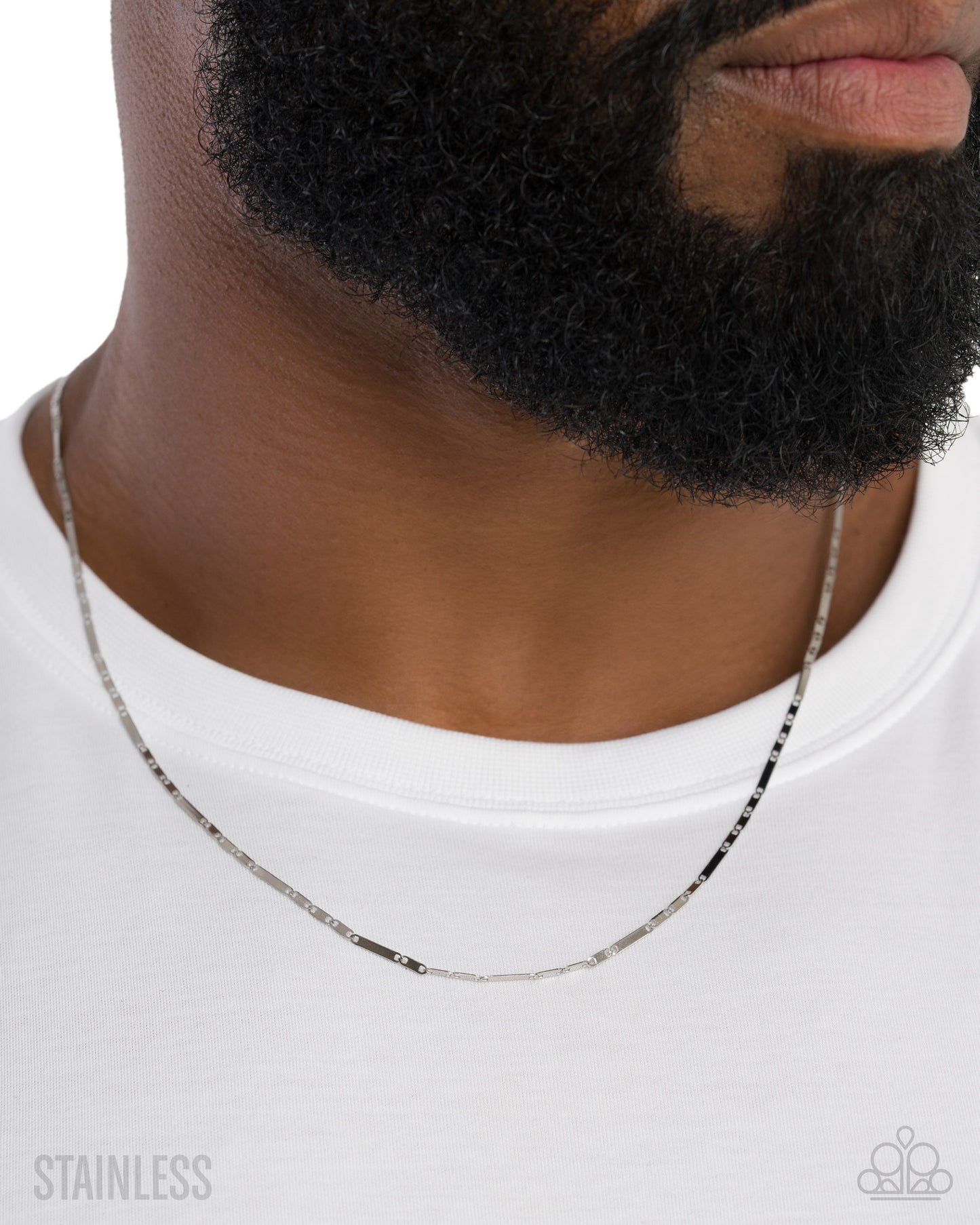 Man wearing a silver chain necklace on a white background