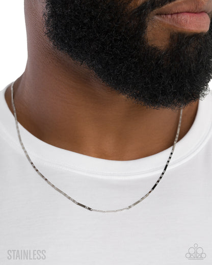 Man wearing a silver chain necklace on a white background