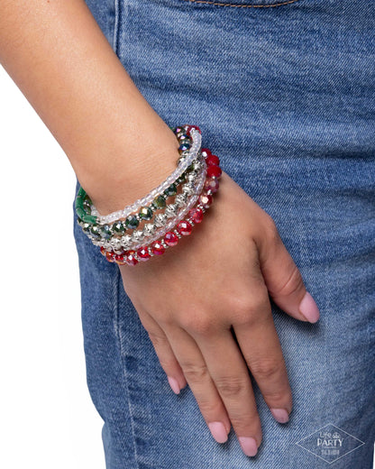 Hand wearing colorful beaded bracelets with a denim background