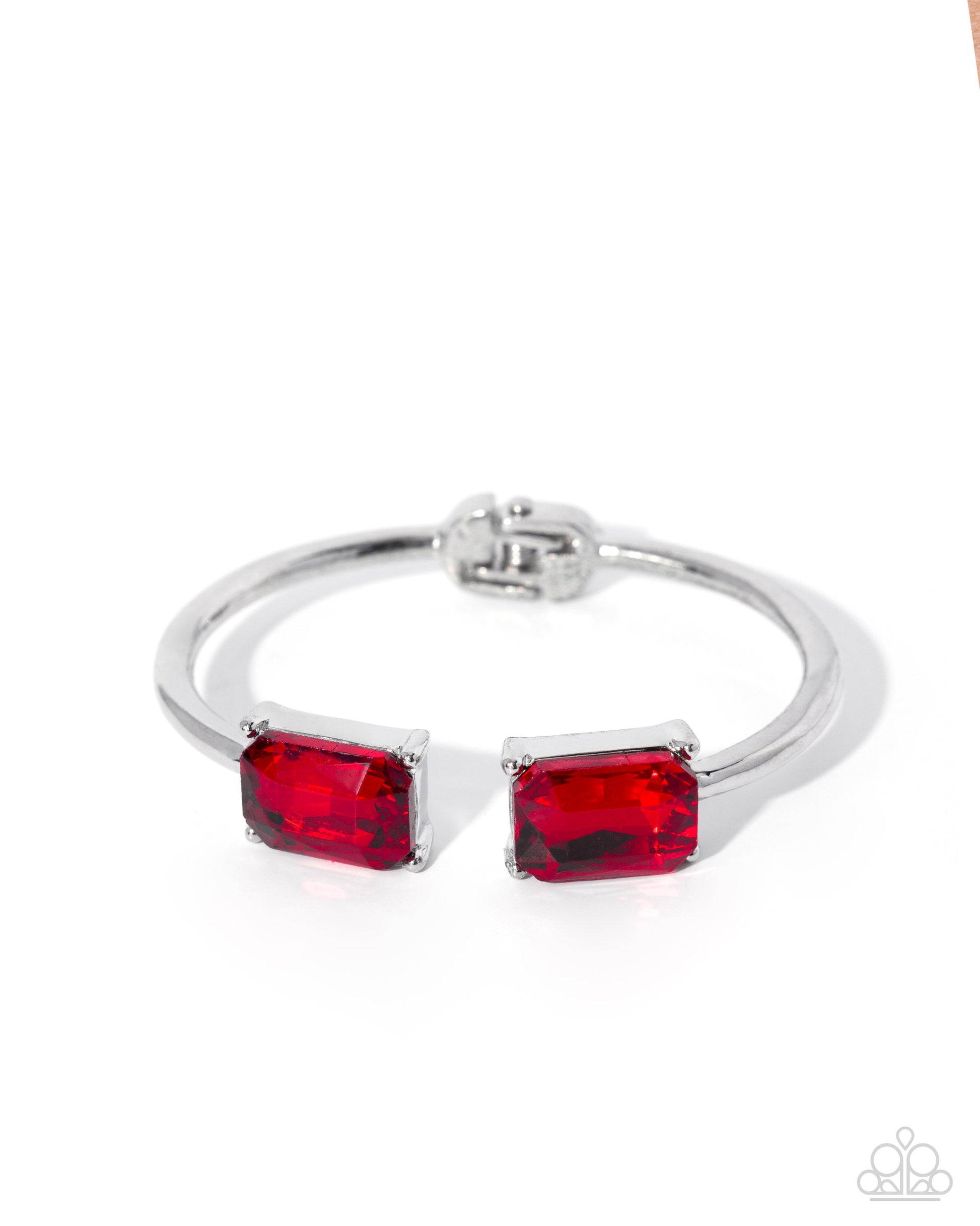 Silver bracelet with red gemstones on a white background
