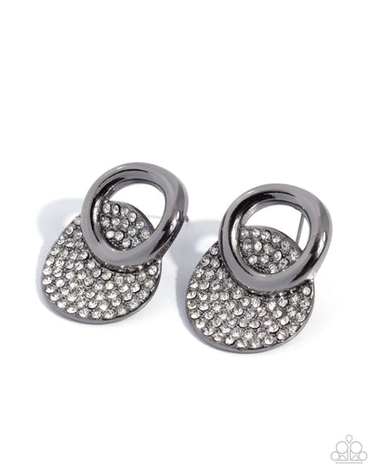 Pair of silver earrings with circular designs and rhinestone embellishments on a white background