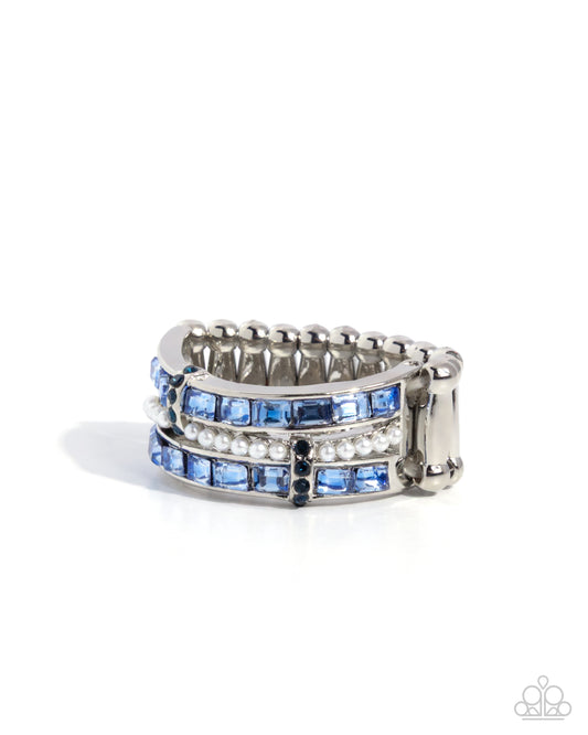Stack of silver rings with blue gemstones on a white background