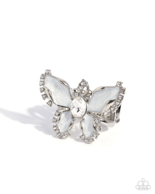 Silver butterfly brooch with gemstones on a white background