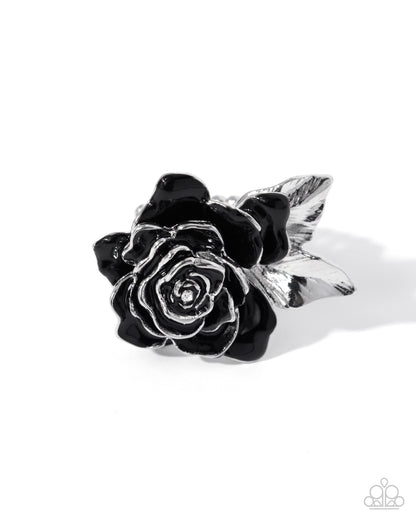 Silver ring with black rose design on a white background