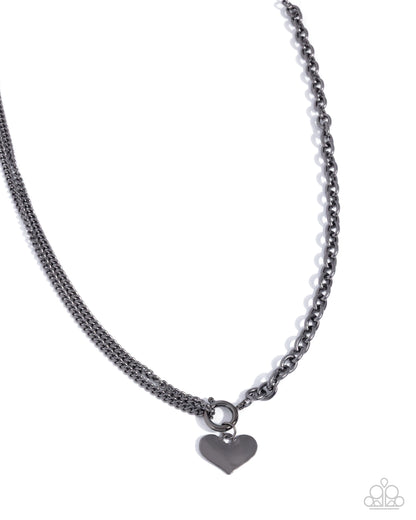 Black chain necklace with a heart-shaped pendant on a white background