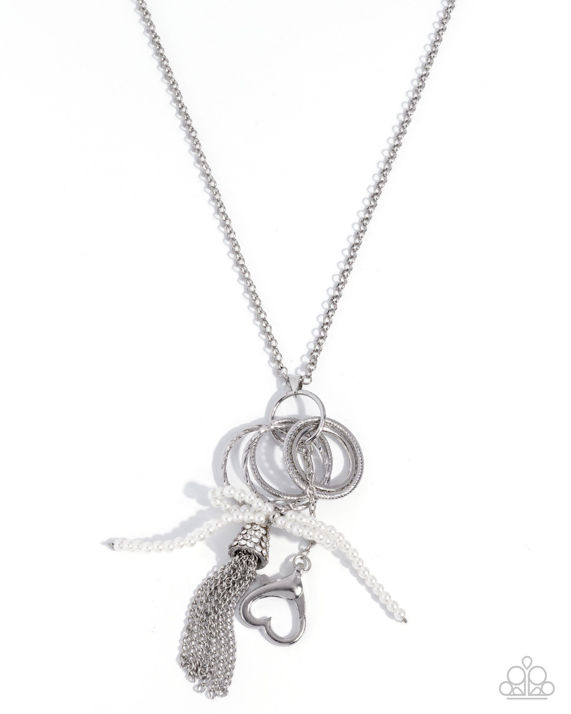Silver necklace with various charms on a white background