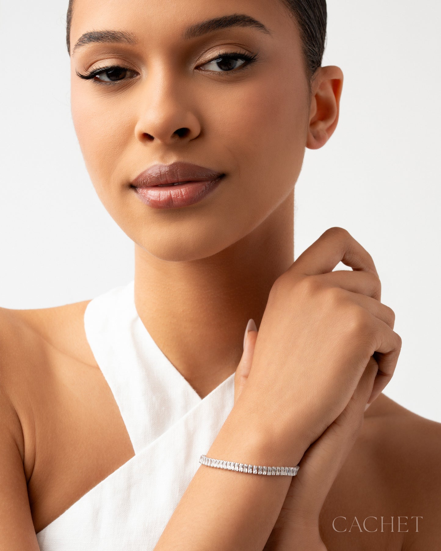 Woman wearing a bracelet with a neutral background