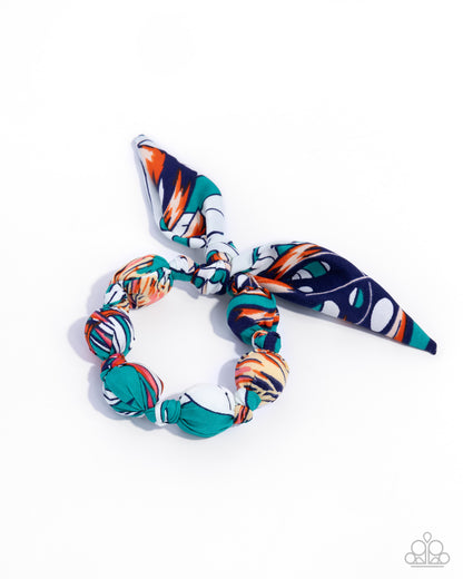 Colorful hair scrunchie and headband set on a white background