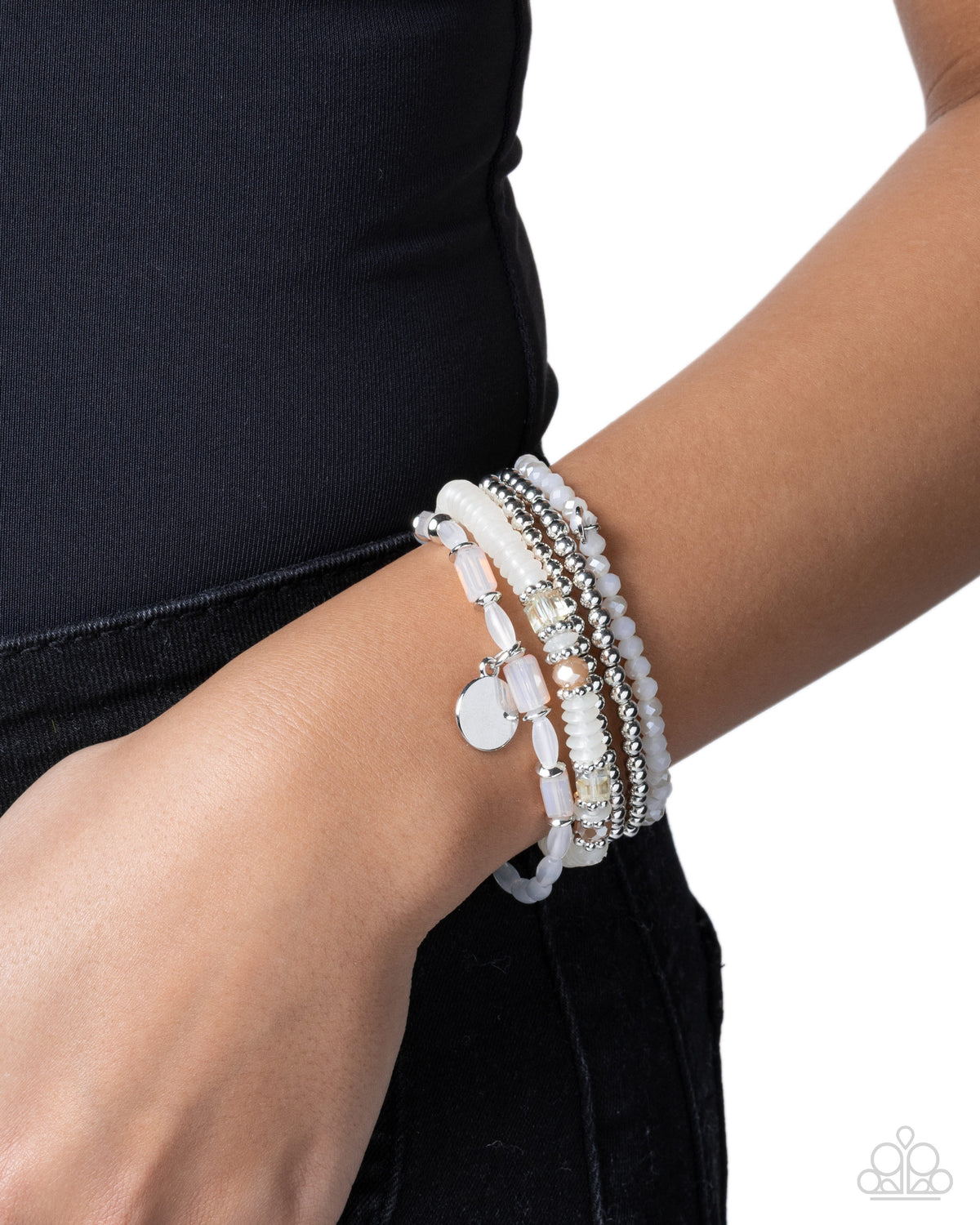 Close-up of Semester Strands white and silver bracelet stack