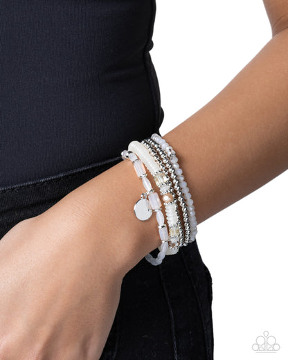 Close-up of Semester Strands white and silver bracelet stack