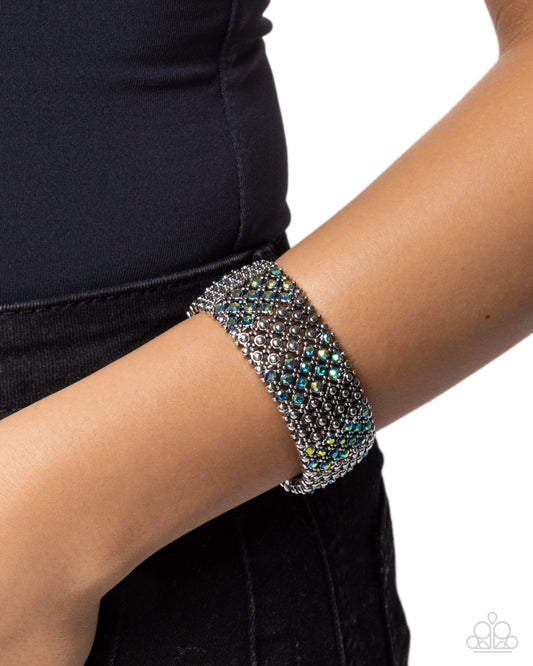 Silver beaded bracelet on a wrist against a white background