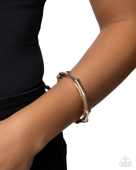 Rose gold bracelet on a wrist with a white background