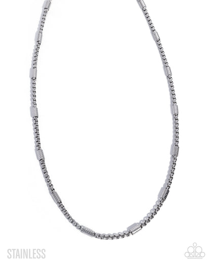 Silver beaded necklace on a white background