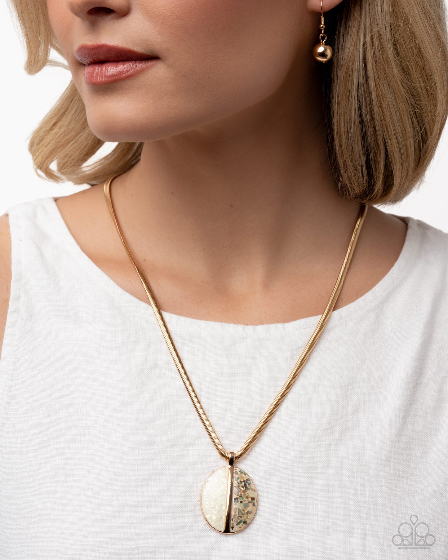 Close-up of a woman wearing a gold necklace and earrings on a white background