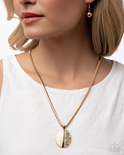 Close-up of a woman wearing a gold necklace and earrings on a white background