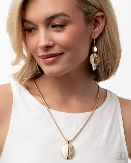 Woman wearing a gold necklace and earrings on a white background