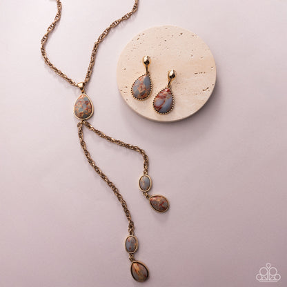 Jewelry set with necklace and earrings on a pink background