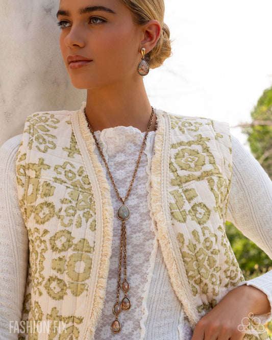 Woman wearing a patterned vest with a neutral background