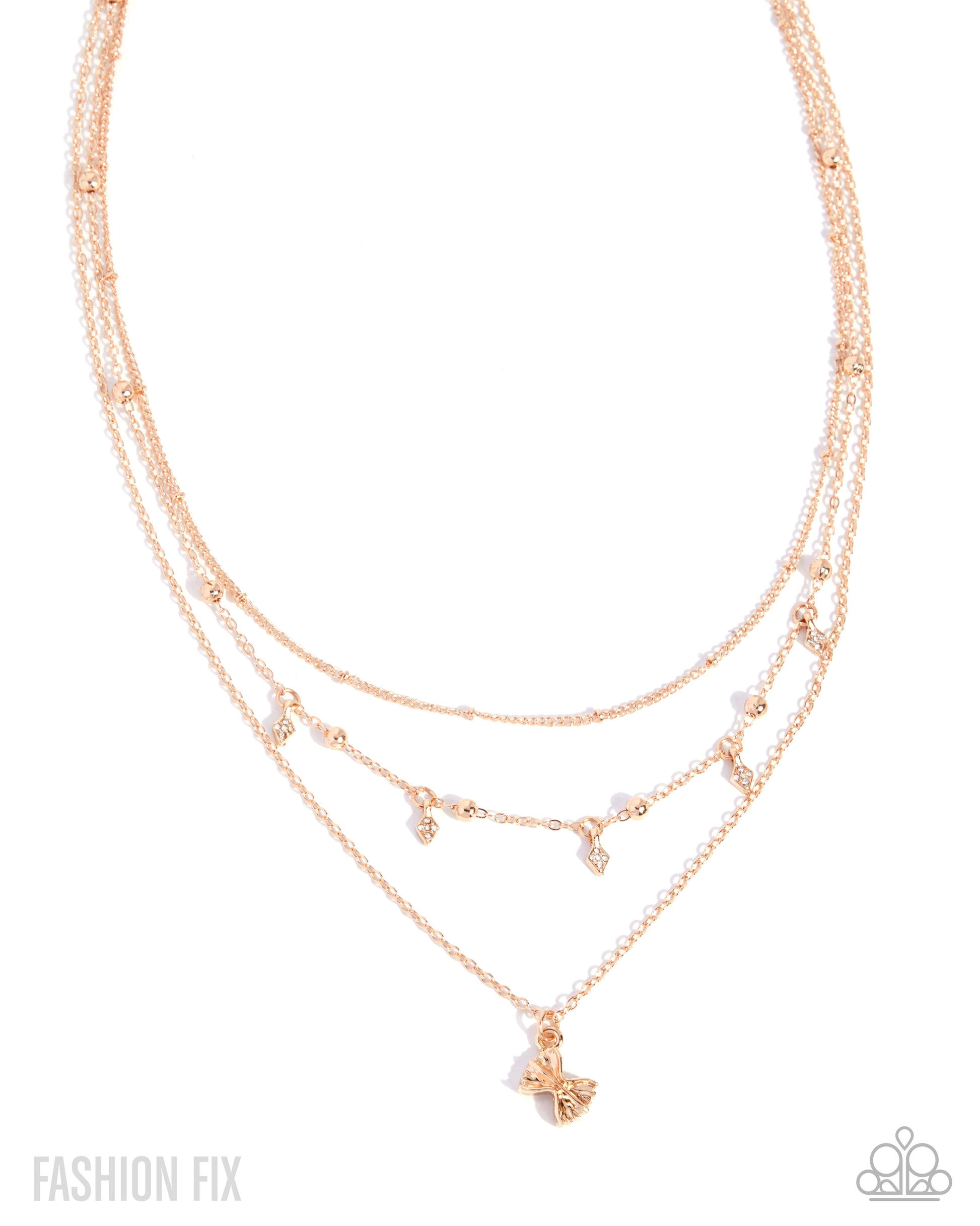 A rose gold multi-layered necklace with delicate chains, small bead accents, and a butterfly pendant, shown on a white background with 'FASHION FIX' text in the corner.