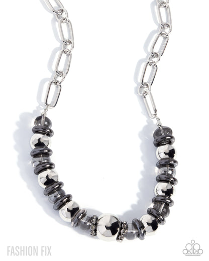 A silver paperclip chain necklace featuring a central beaded section with alternating polished silver and dark gray metallic beads, displayed on a clean white background.