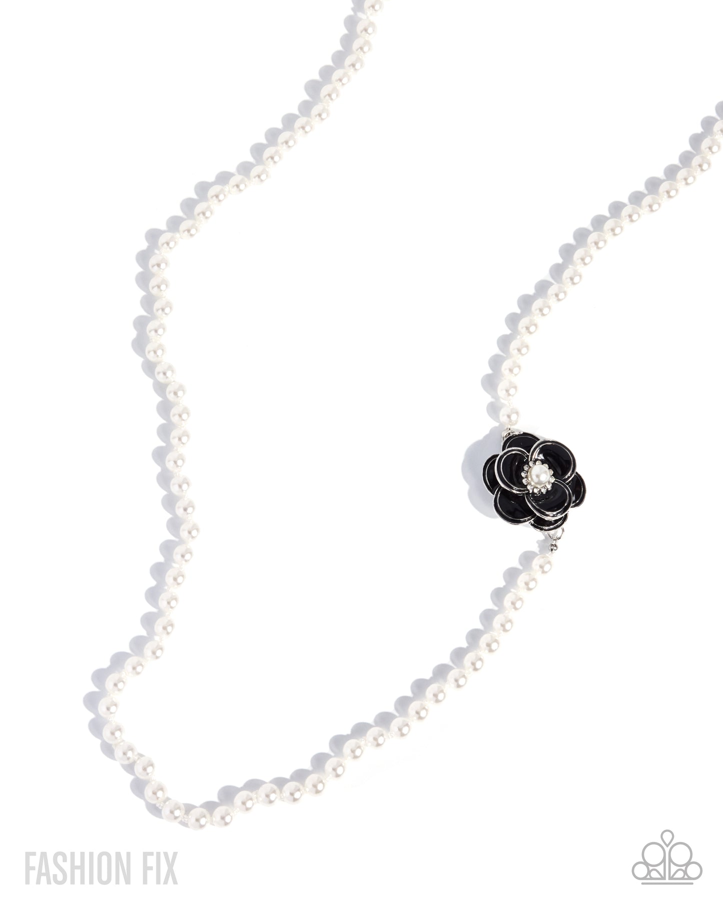 A white pearl necklace with a black flower-shaped charm featuring a clear crystal center, displayed on a clean white background with soft shadows.