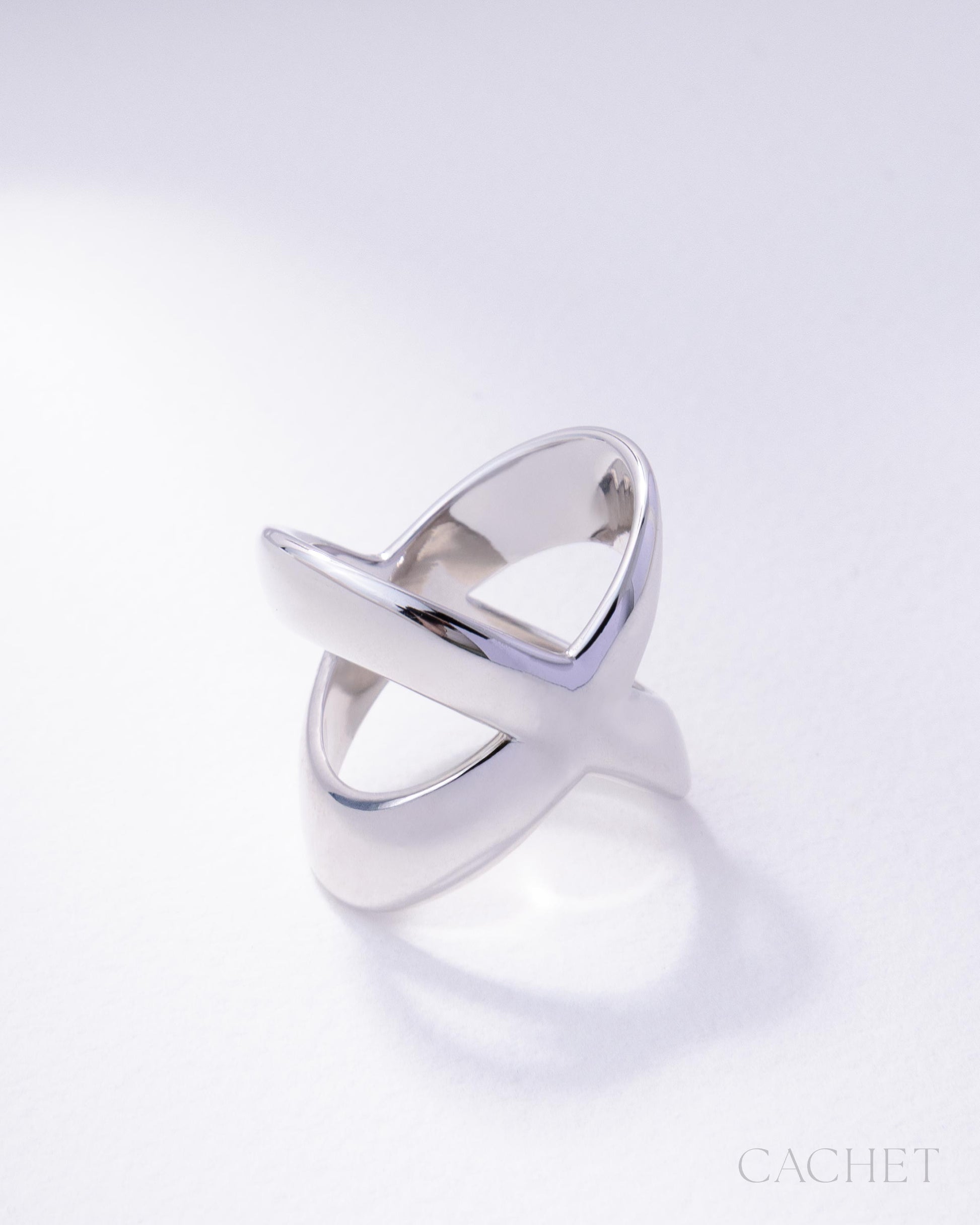 Silver ring with a modern design on a white background, featuring the brand 'Cachet'.