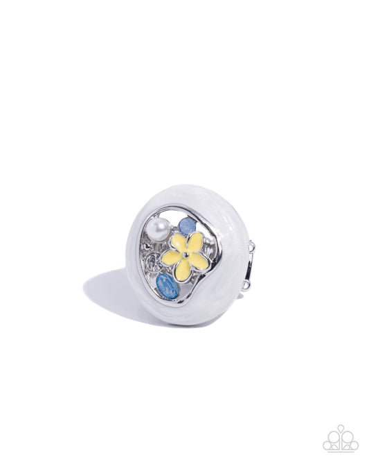 White circular object with floral design on a white background