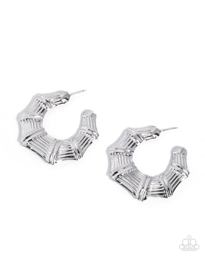 Silver hoop earrings with geometric design on a white background