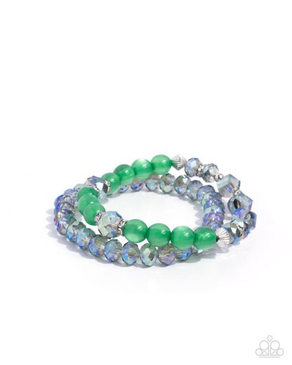 Green beaded bracelet with silver accents on a white background