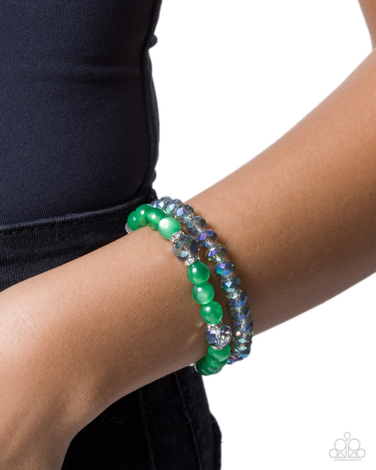 Green beaded bracelet on a wrist with a white background