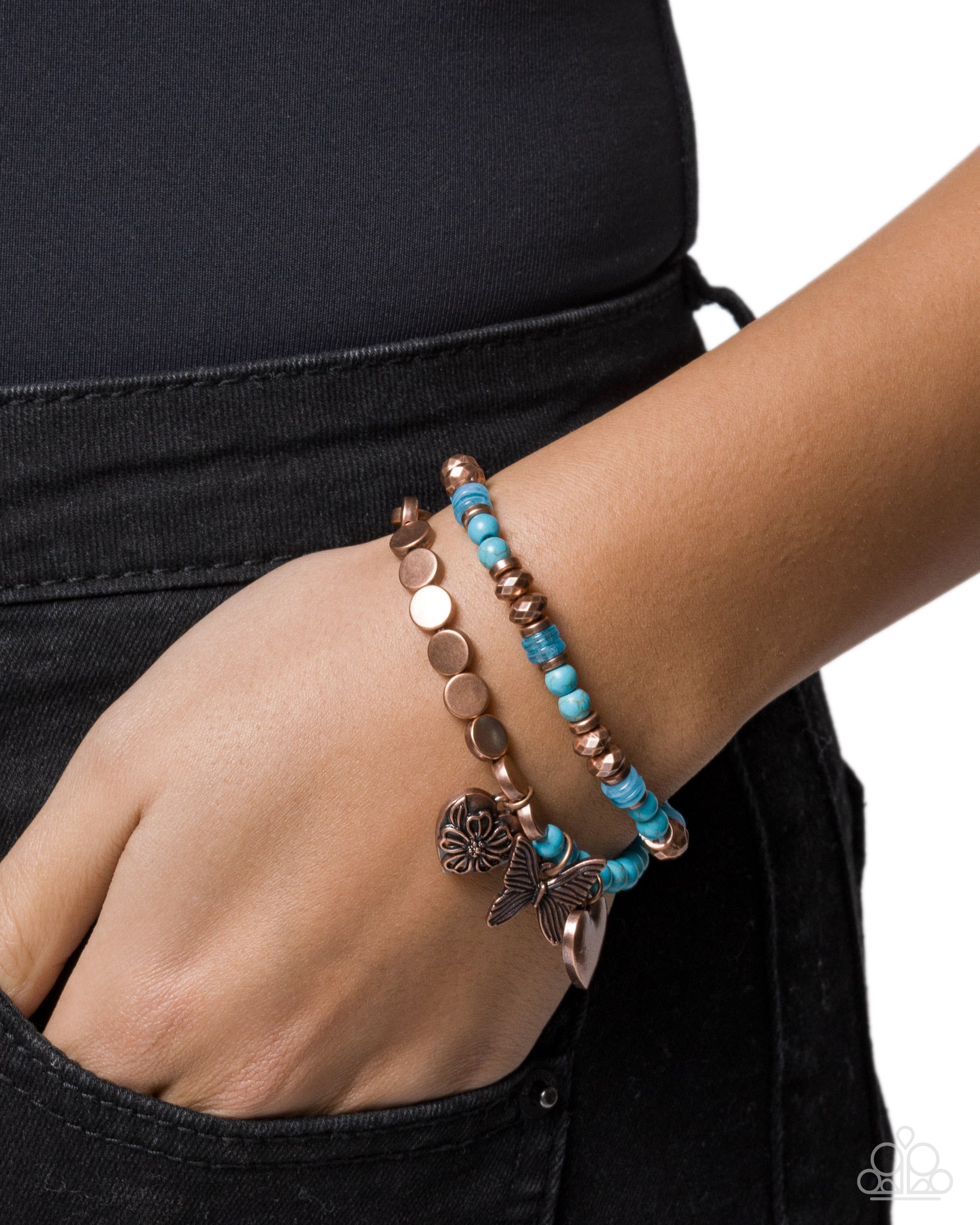 Turquoise and copper beaded bracelet on a wrist with a plain background