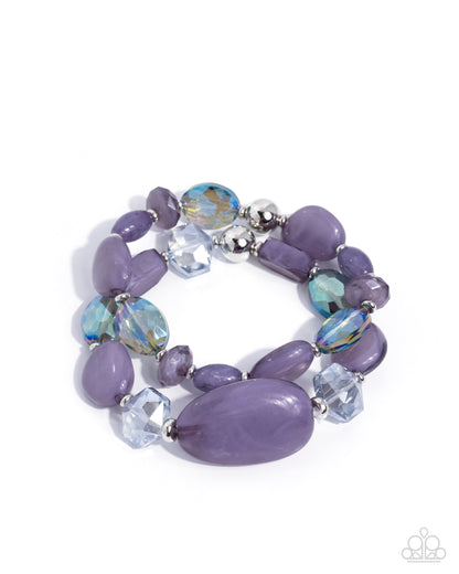 Purple beaded bracelet with silver accents on a white background