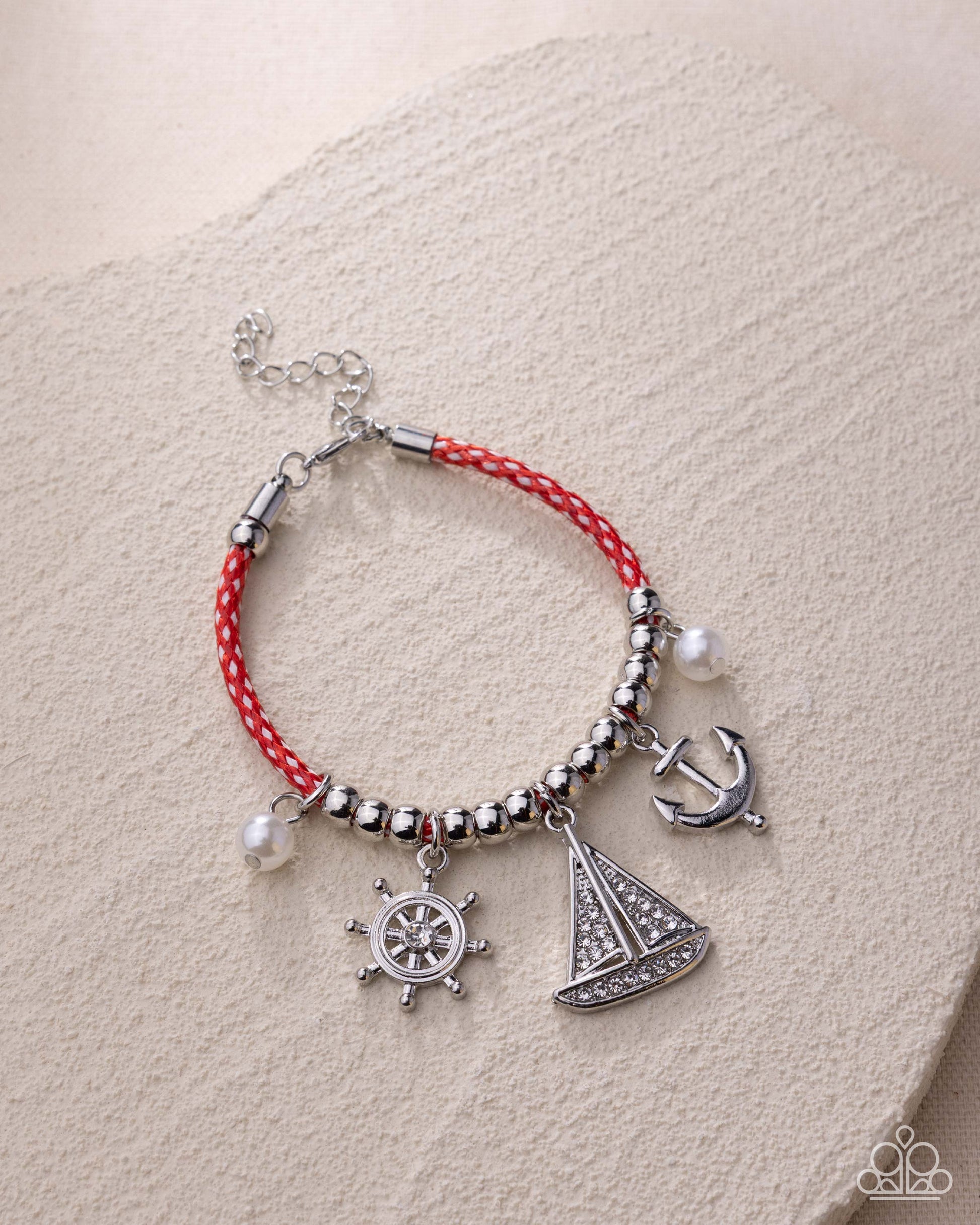 Bracelet with nautical charms on a beige background