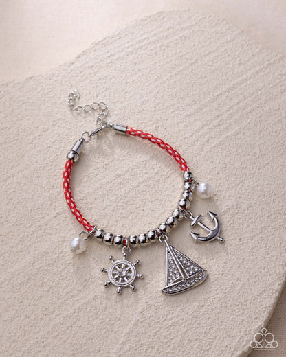 Bracelet with nautical charms on a beige background