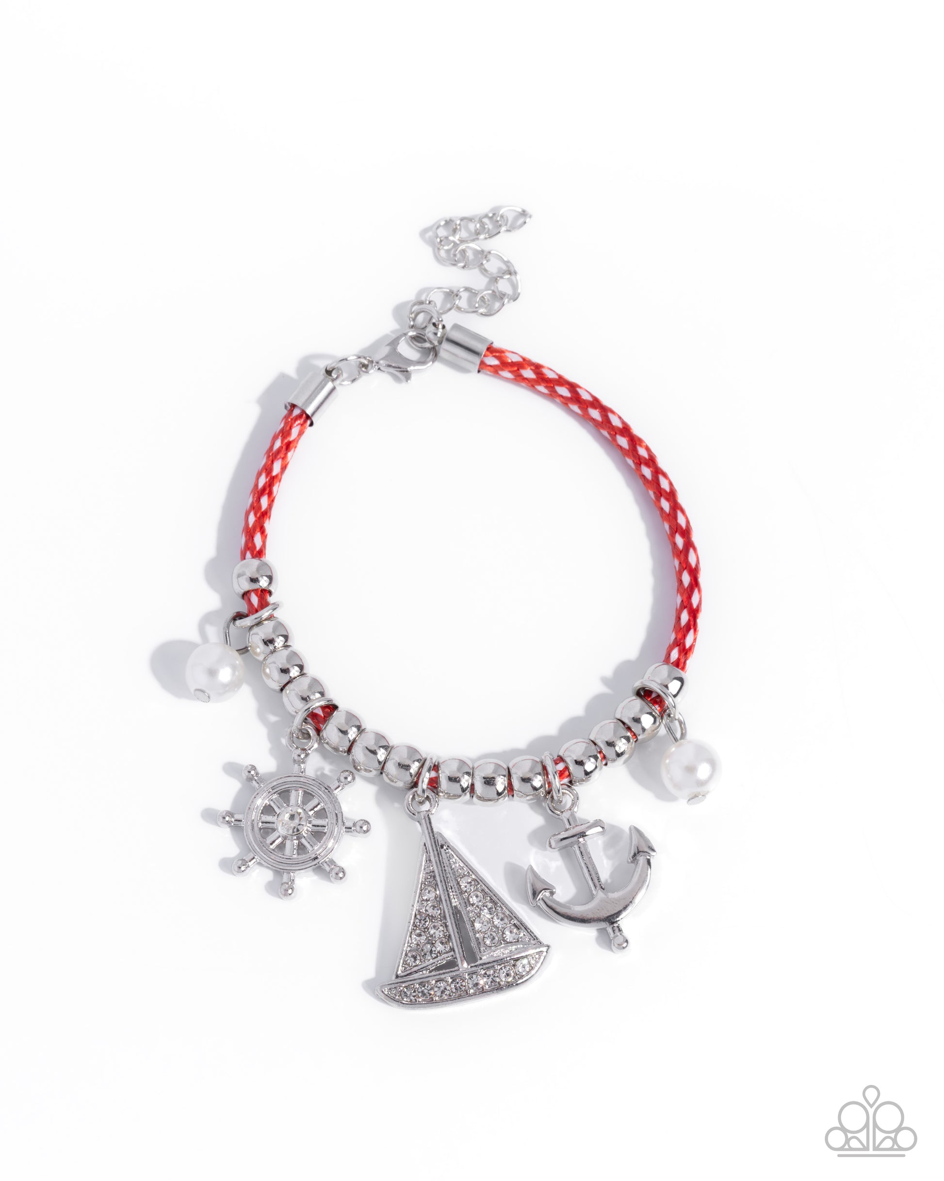 Bracelet with red cord, silver charms, and decorative elements on a white background