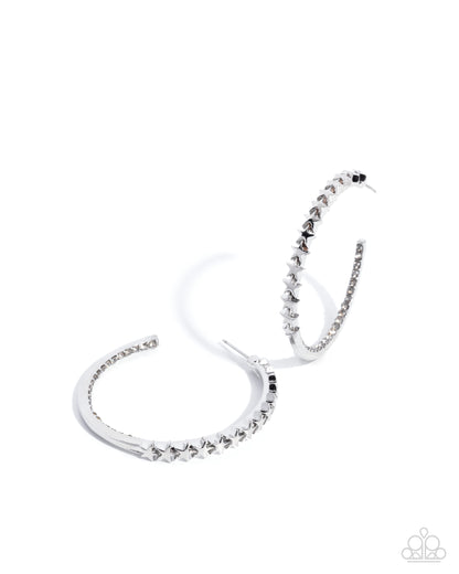 Silver hoop earrings with embedded stones on a white background