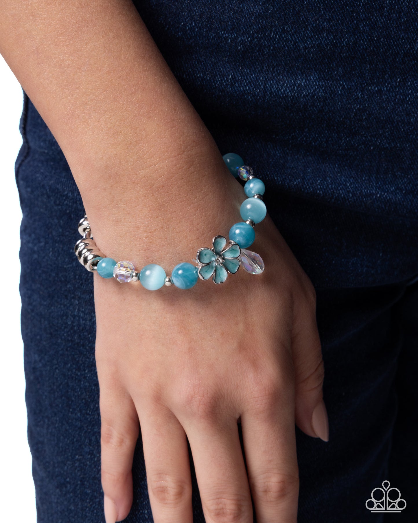 Turquoise beaded bracelet on a wrist with a dark blue background