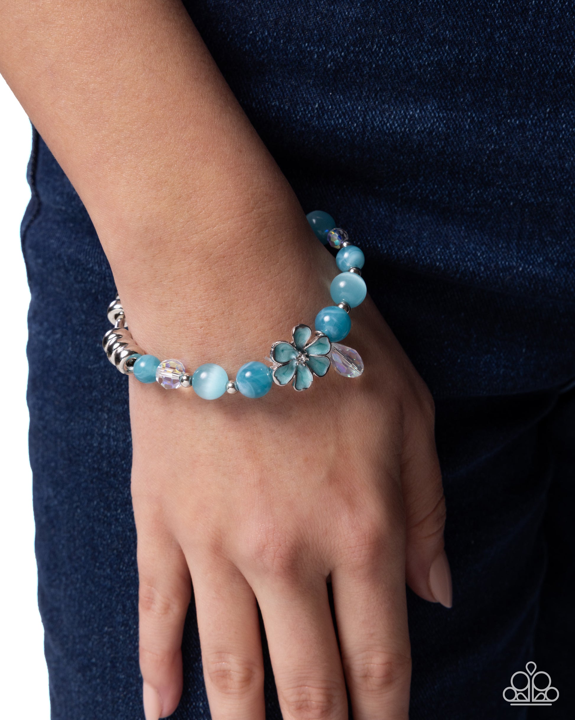 Turquoise beaded bracelet on a wrist with a dark blue background