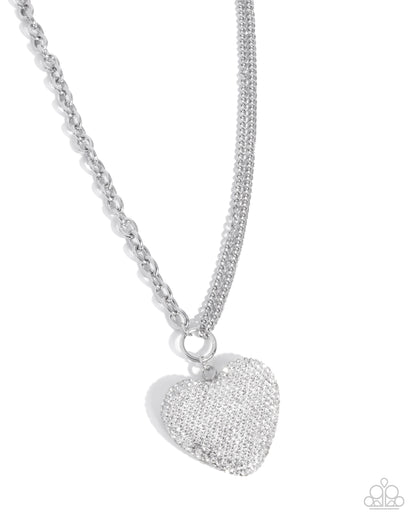 Silver heart-shaped pendant on a chain against a white background