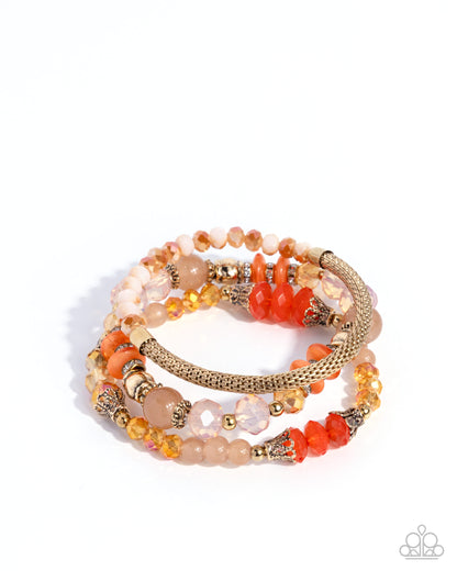 Stack of beaded bracelets with orange, pink, and gold tones on a white background