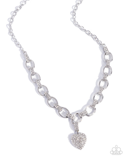 Silver chain necklace with a heart-shaped pendant on a white background